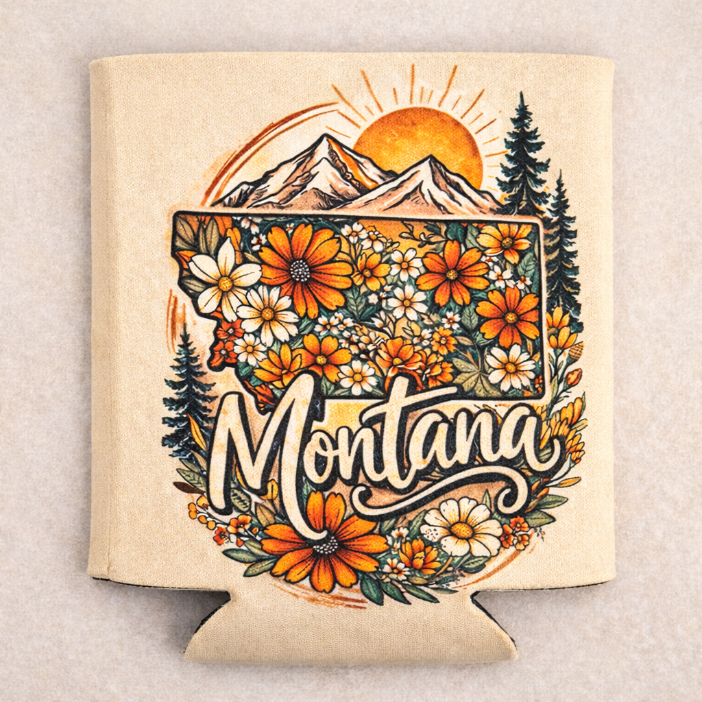 Montana-themed can cooler with floral design and mountain landscape on a beige background